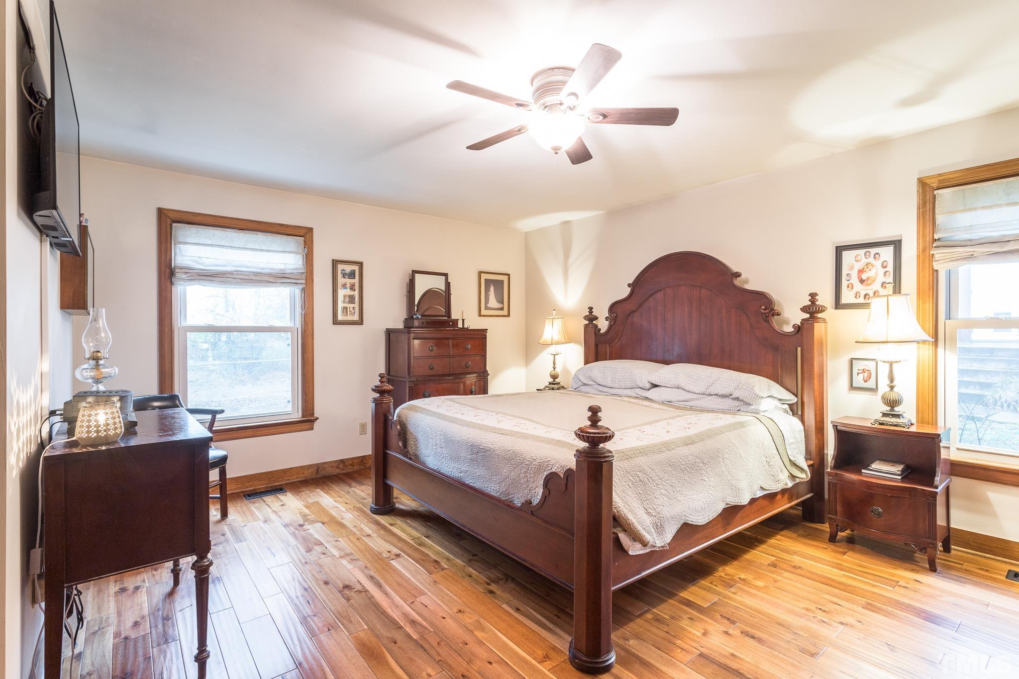 3021 Peebles Road Raleigh, NC 27616 - Photo 22 of 45 a bedroom with a bed and wooden floor