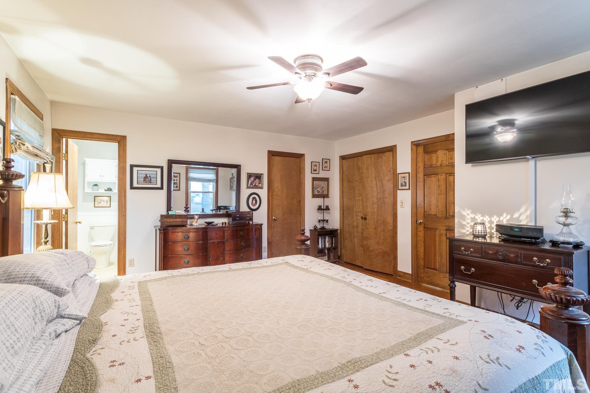3021 Peebles Road Raleigh, NC 27616 - Photo 23 of 45 a bedroom with a large bed and a flat screen tv