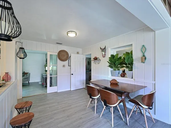 a dining room with furniture and wooden floor