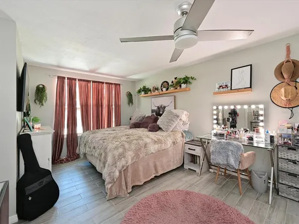 a bedroom with a bed and wooden floor