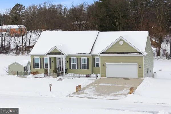a view of a white house with a yard covered in snow