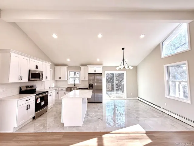 a kitchen with refrigerator and microwave
