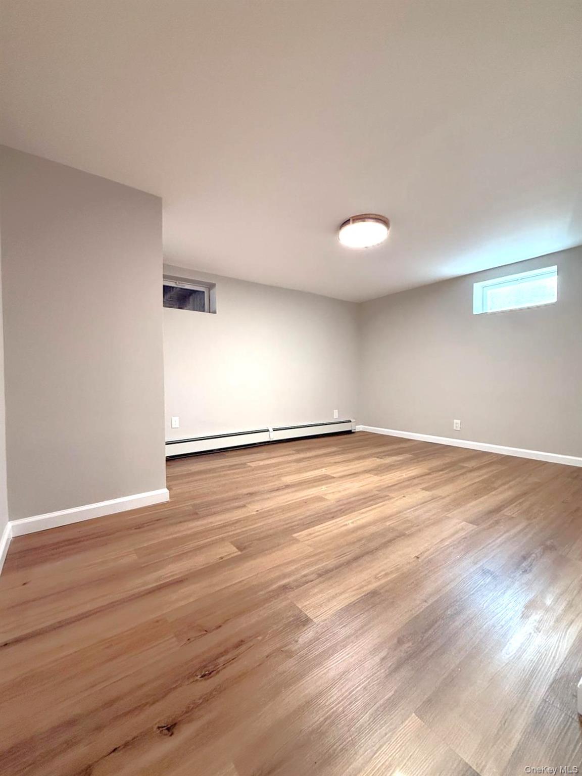 53 West Yaphank Road Medford, NY 11763 - Photo 16 of 24 a view of an empty room with wooden floor and windows