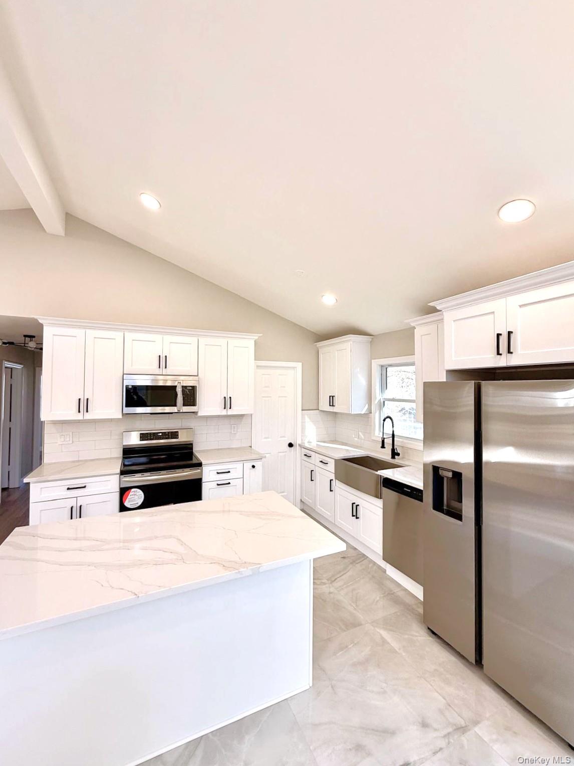 53 West Yaphank Road Medford, NY 11763 - Photo 5 of 24 a kitchen with kitchen island a counter top space a refrigerator cabinets and a sink