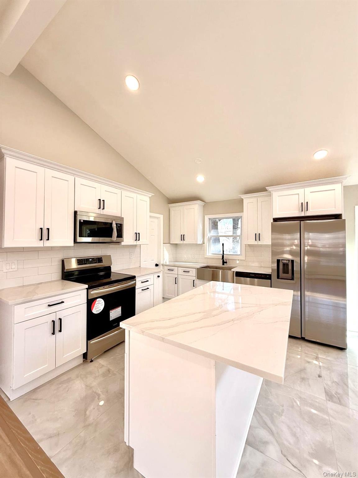 53 West Yaphank Road Medford, NY 11763 - Photo 6 of 24 a kitchen with stainless steel appliances kitchen island granite countertop a stove top oven a sink dishwasher and a refrigerator with white cabinets