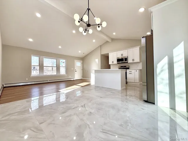 a view of a kitchen with a sink and microwave