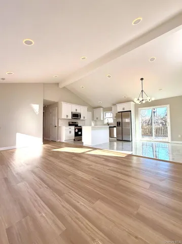 a view of a kitchen with a sink and a large window