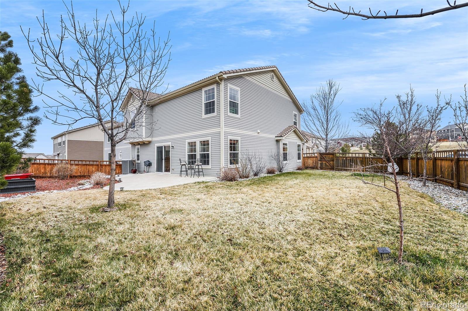 1822 Coach House Loop Castle Rock, CO 80109 - Photo 11 of 35 a white house that has a tree in front of it