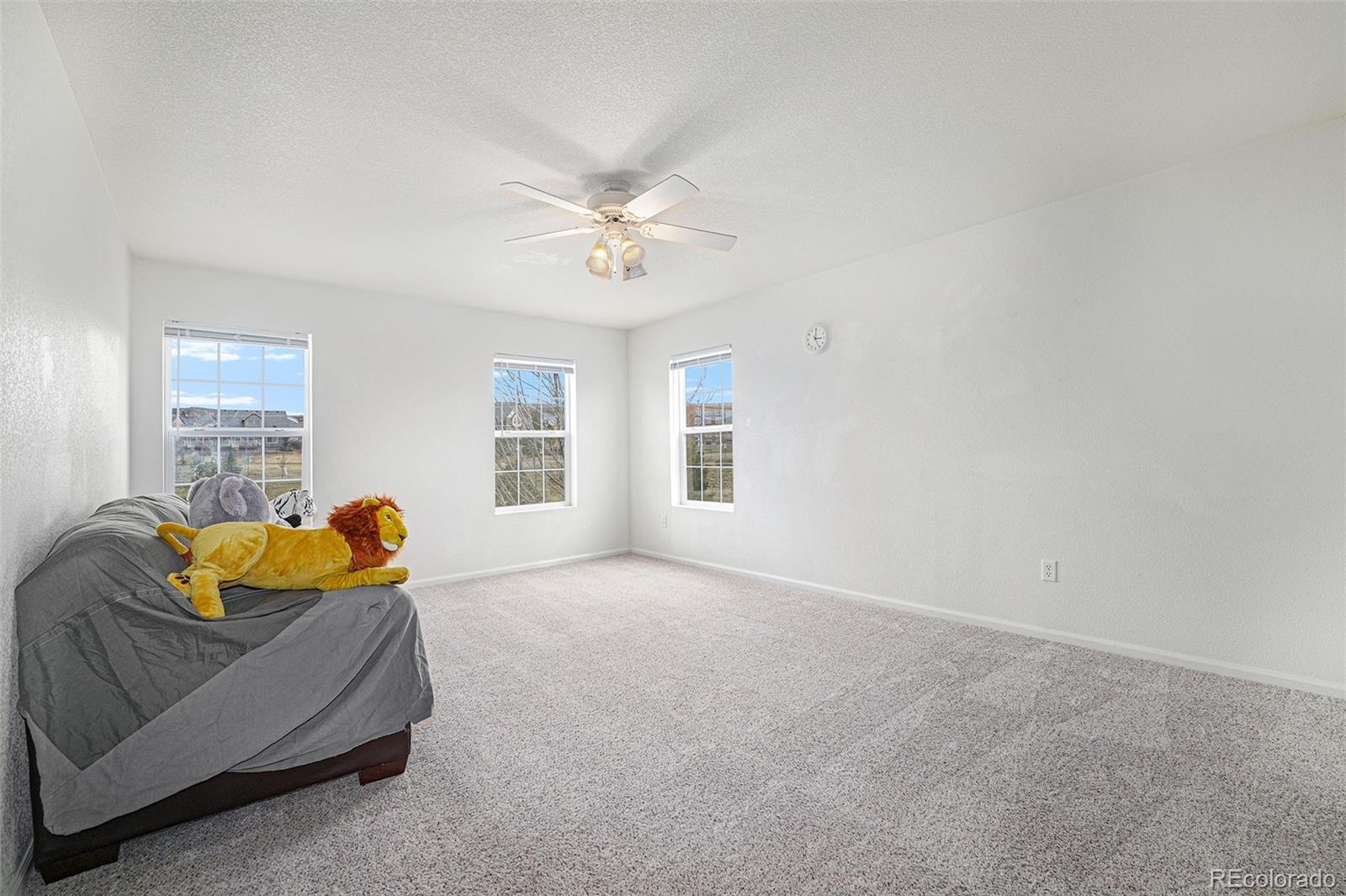 1822 Coach House Loop Castle Rock, CO 80109 - Photo 17 of 35 a bedroom with a bed and ceiling fan