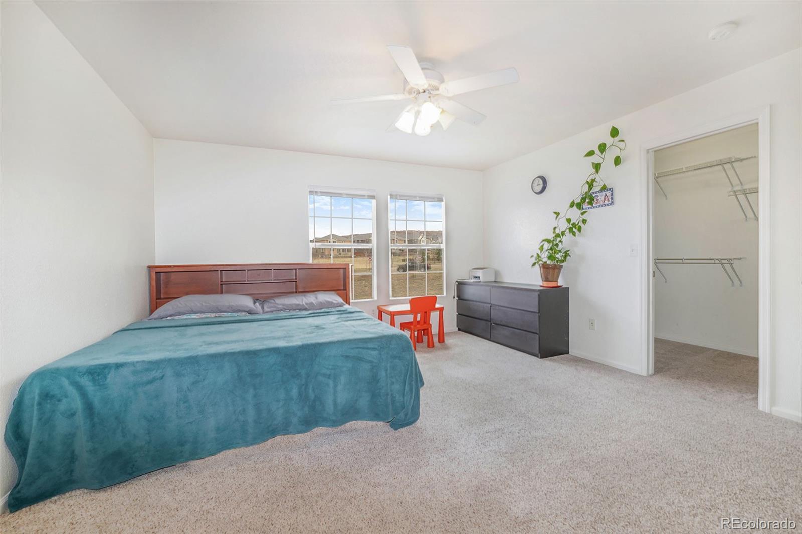 1822 Coach House Loop Castle Rock, CO 80109 - Photo 20 of 35 a bedroom with a bed and ceiling fan
