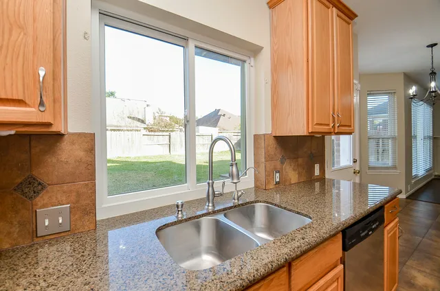 a kitchen with granite countertop a sink and a window