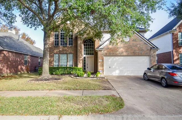 a view of a car parked in front of a house