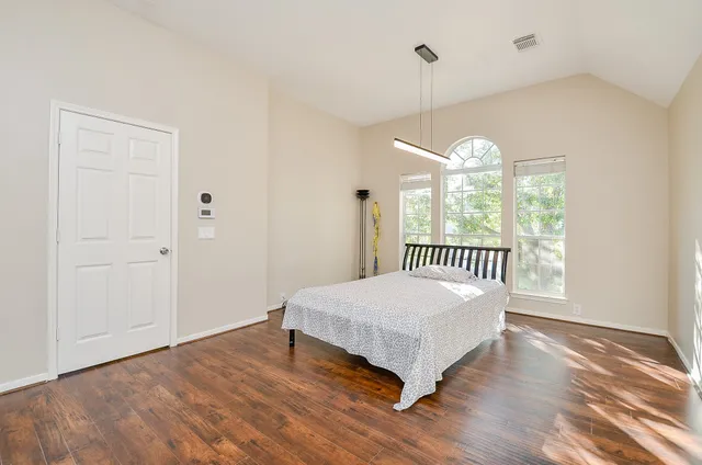 a bedroom with a bed and a window