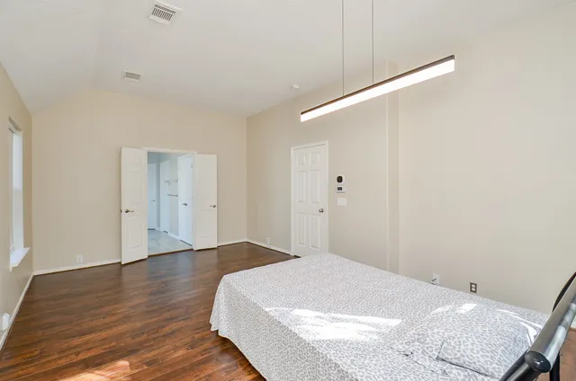 a view of a room with wooden floor and white walls
