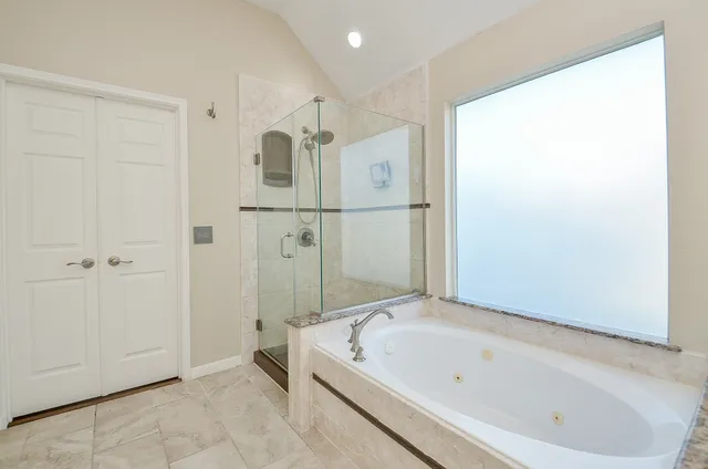 a bathroom with a bathtub and a shower