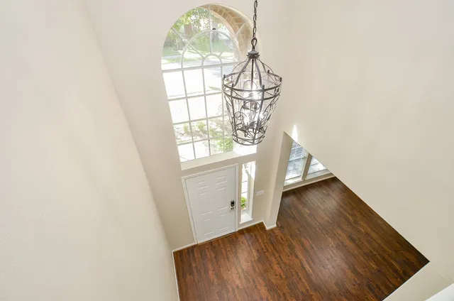 an entryway with wooden floor and staircase