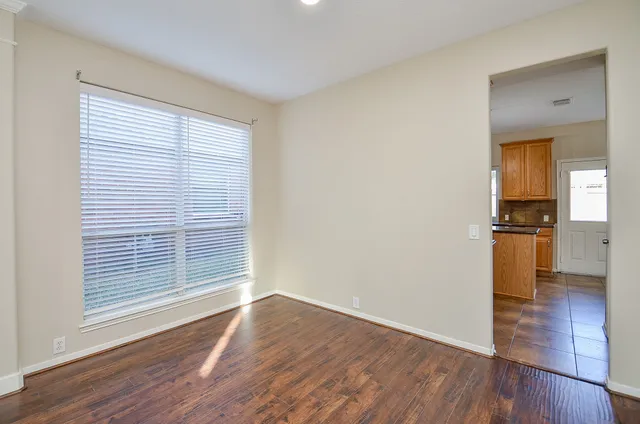 a view of kitchen with wooden floor electronic appliances and window
