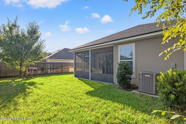 a view of backyard of house with green space