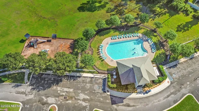 an aerial view of a house with a swimming pool and outdoor space