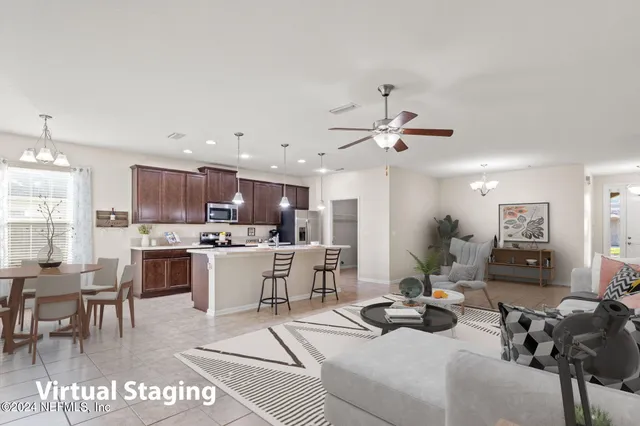 a living room with stainless steel appliances kitchen island granite countertop furniture and a view of living room