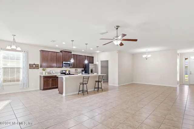 a view of kitchen with sink microwave and cabinets