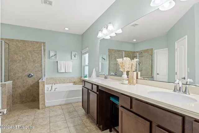 a spacious bathroom with a granite countertop sink a toilet a mirror and shower