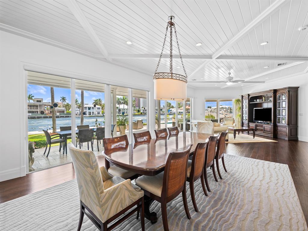 2898 Northeast 26th Street Fort Lauderdale, FL 33305 - Photo 12 of 77 a dining room with furniture a chandelier and wooden floor