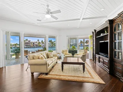 a kitchen with cabinets a sink dishwasher a dining table and chairs with wooden floor