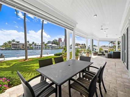a bathroom with a tub sink double vanity and windows