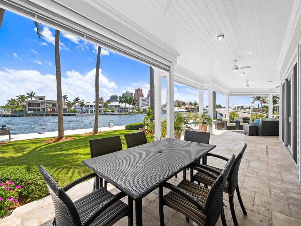 2898 Northeast 26th Street Fort Lauderdale, FL 33305 - Photo 26 of 77 a view of a patio with a table chairs and a swimming pool