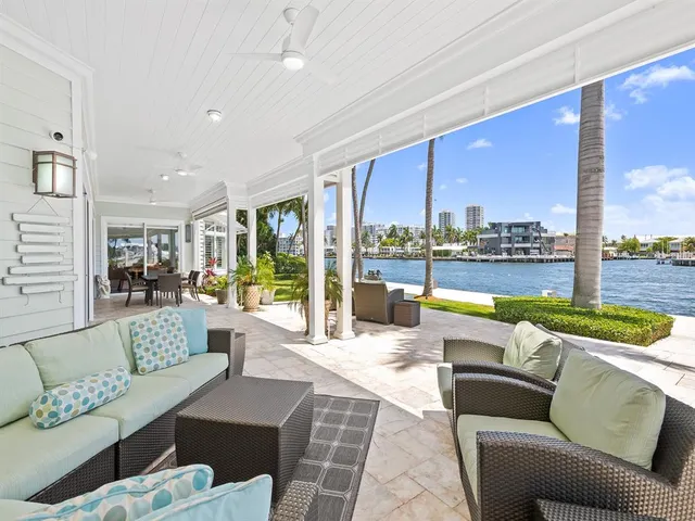 a balcony with furniture and a lake view