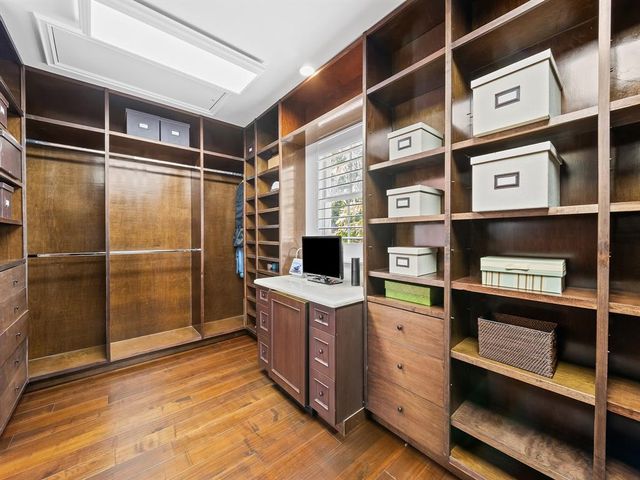 a living room with furniture a floor to ceiling window and a kitchen view