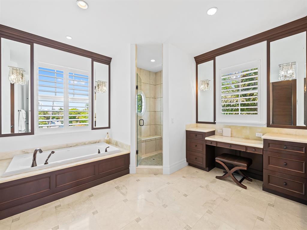 2898 Northeast 26th Street Fort Lauderdale, FL 33305 - Photo 43 of 77 a bathroom with a tub sink double vanity and windows