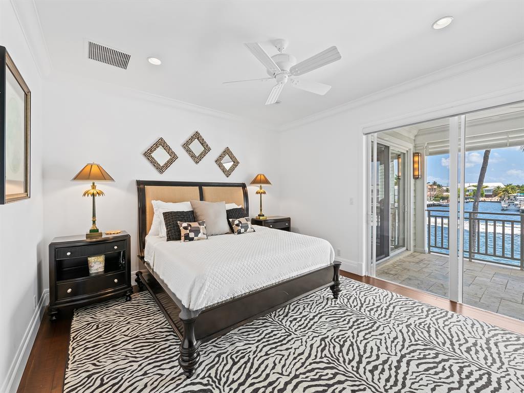 2898 Northeast 26th Street Fort Lauderdale, FL 33305 - Photo 45 of 77 a bedroom with a bed a table and painting on the wall