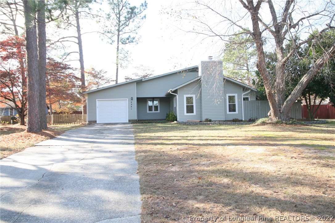 6241 Stoney Point Loop Fayetteville, NC 28306 - Photo 1 of 40 a view of a white house with a large tree and a yard