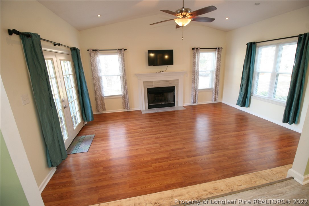 6241 Stoney Point Loop Fayetteville, NC 28306 - Photo 11 of 40 wooden floor in an empty room with a fireplace