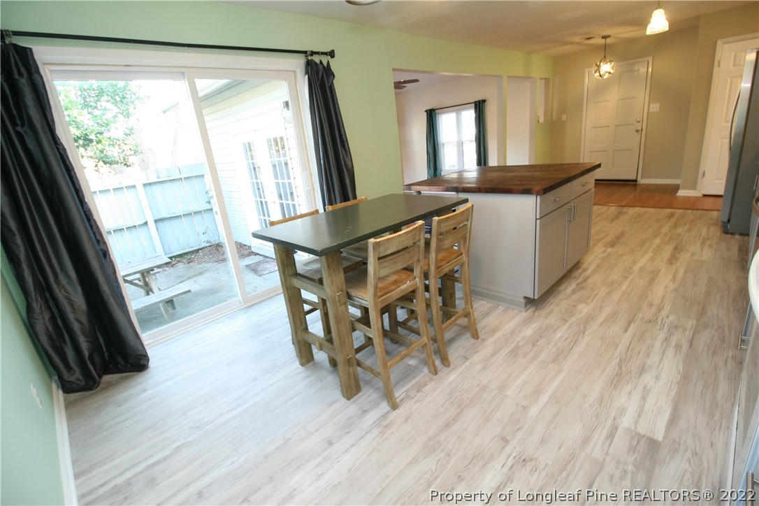 6241 Stoney Point Loop Fayetteville, NC 28306 - Photo 17 of 40 a view of a dining room with furniture and wooden floor