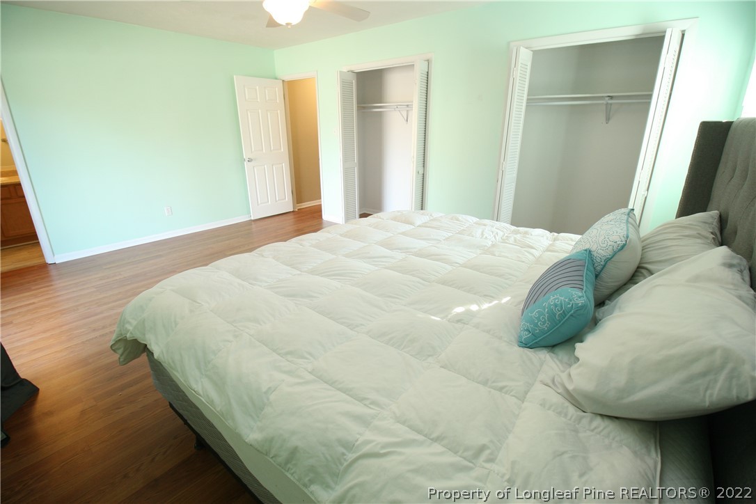 6241 Stoney Point Loop Fayetteville, NC 28306 - Photo 22 of 40 a bedroom with a bed and a mirror