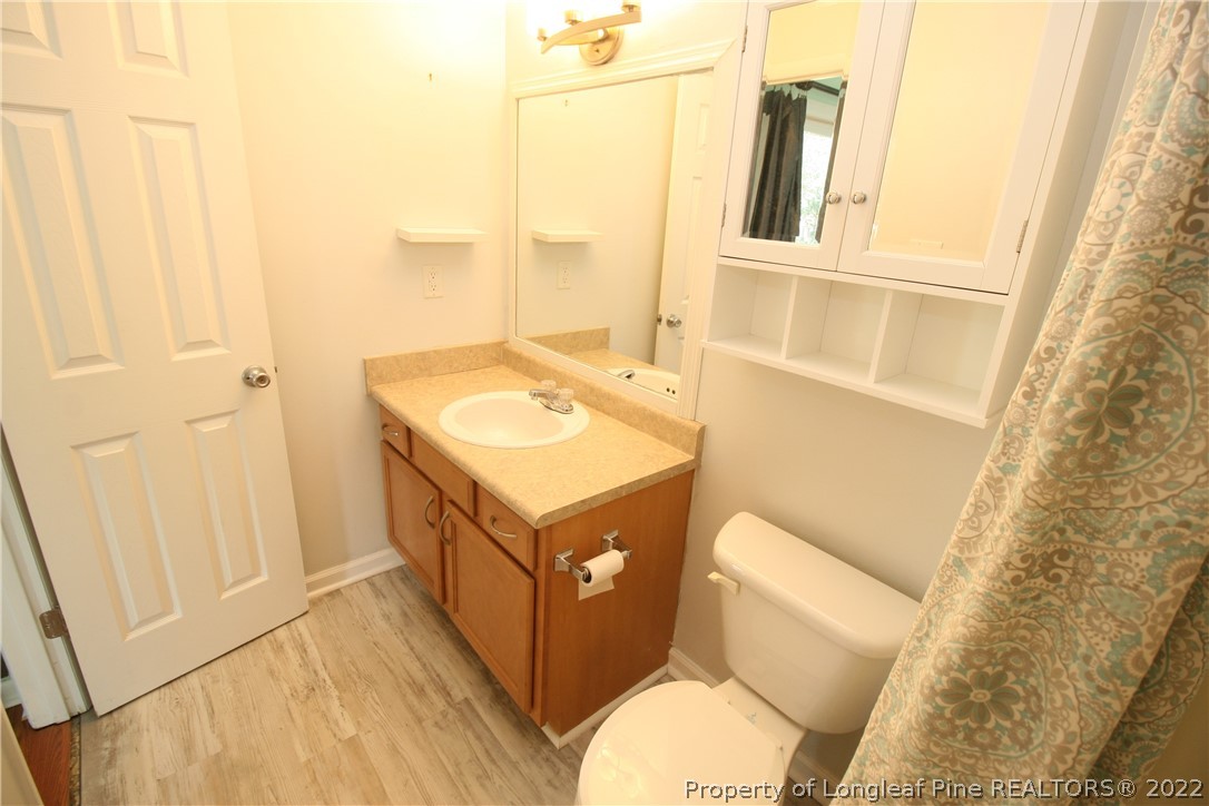 6241 Stoney Point Loop Fayetteville, NC 28306 - Photo 25 of 40 a bathroom with a sink a toilet and a mirror