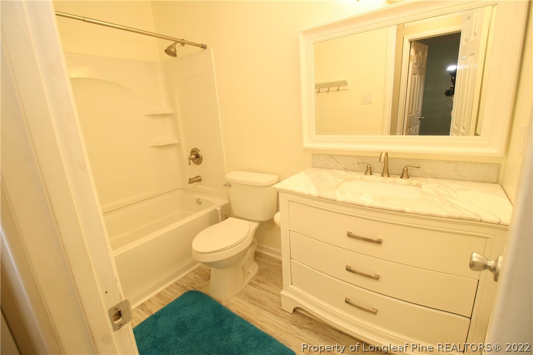 6241 Stoney Point Loop Fayetteville, NC 28306 - Photo 28 of 40 a bathroom with a sink a toilet and shower