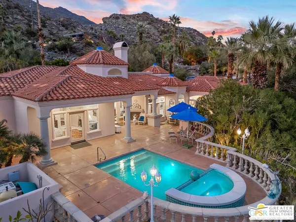 a view of a house with swimming pool and furniture