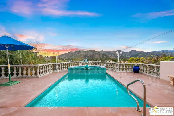 a view of a swimming pool with a patio and a yard