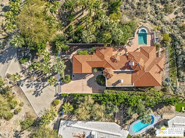 an aerial view of a house with yard and street view