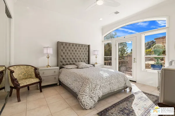 a bedroom with a bed chair and window