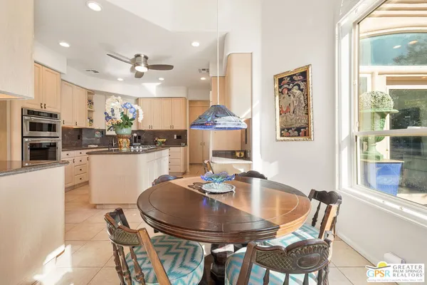 a dining room with furniture a window and kitchen view