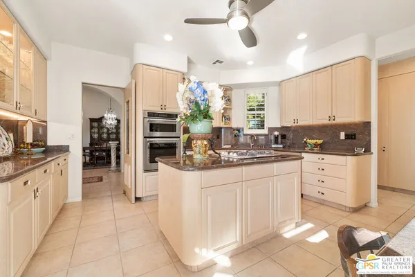 a kitchen with granite countertop a sink counter top space appliances and cabinets