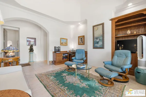 a living room with furniture a rug and a large window