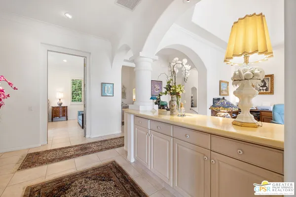 a en suite bathroom with a granite countertop tub and a large mirror