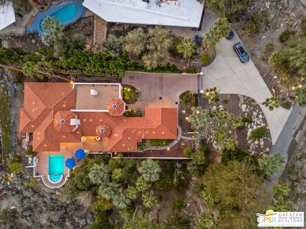 an aerial view of a house with a yard