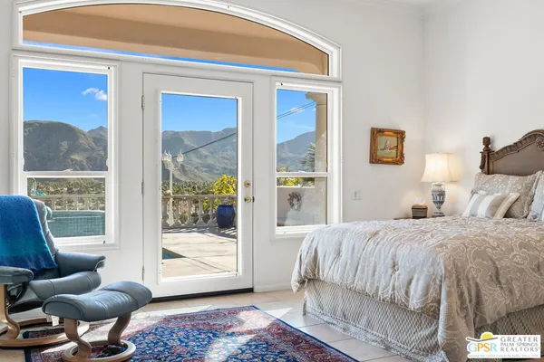 a bedroom with a bed and glass window